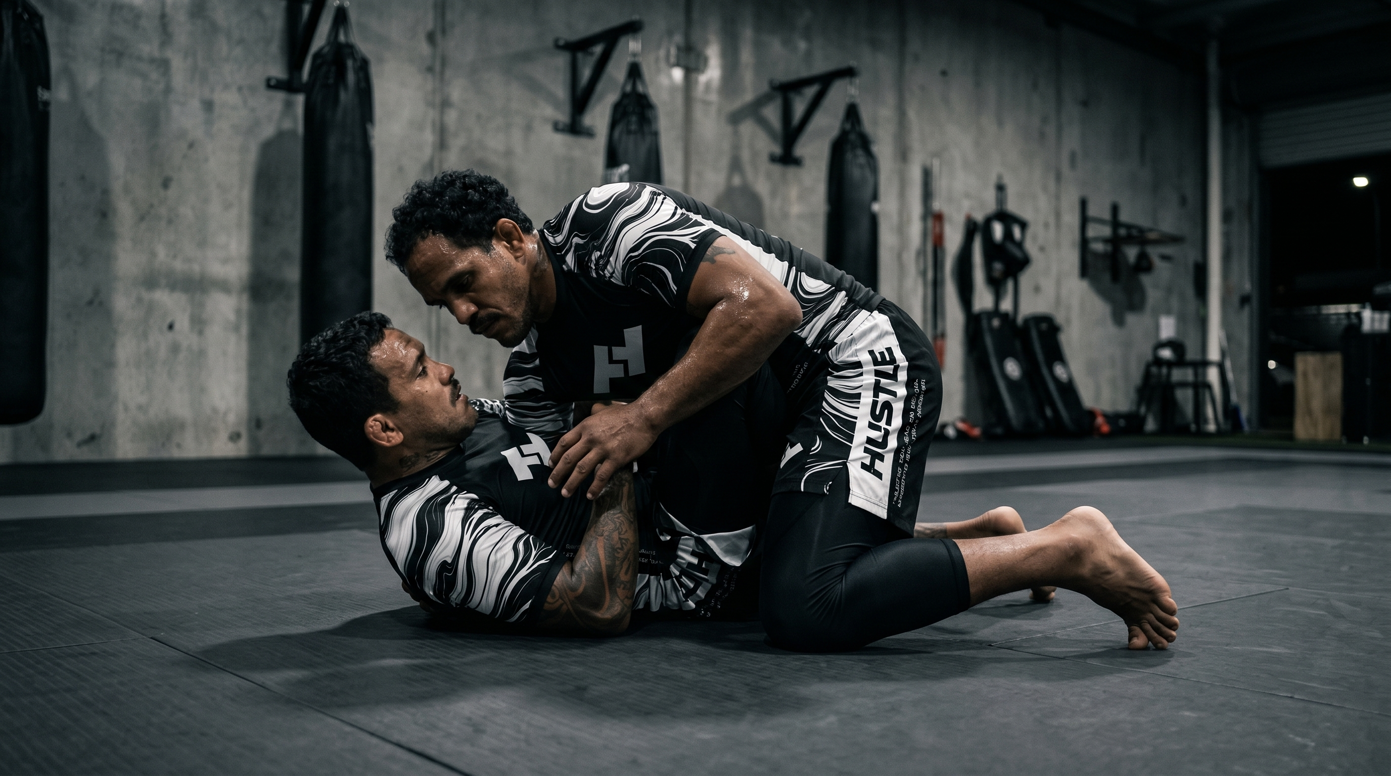 Compétiteur en garde fermée sur tatami en rashguard noir Competitor V2 - guide rashguard noir JJB MMA - Hustle Fightwear